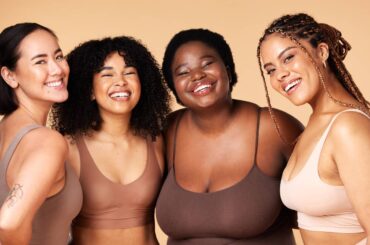 Friends, diversity and beauty of women in underwear in studio isolated on a brown background. Portr.